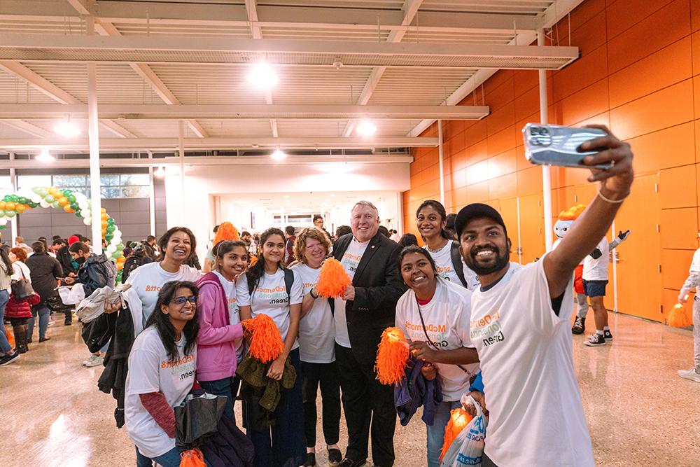 Students take a selfie with President Richard C. Benson and his wife Leslie Benson